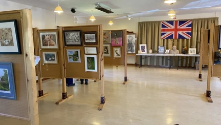 A series of wooden stands with framed pictures attached