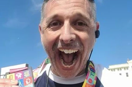 Stuart with a huge smile and his medal around his neck