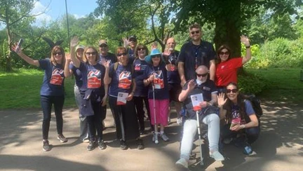 A group shot of all the walkers who took part taken outside under a tree