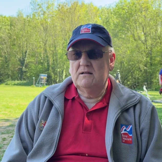 Peter in a Blind Veterans UK baseball cap and fleece and wearing sunglasses