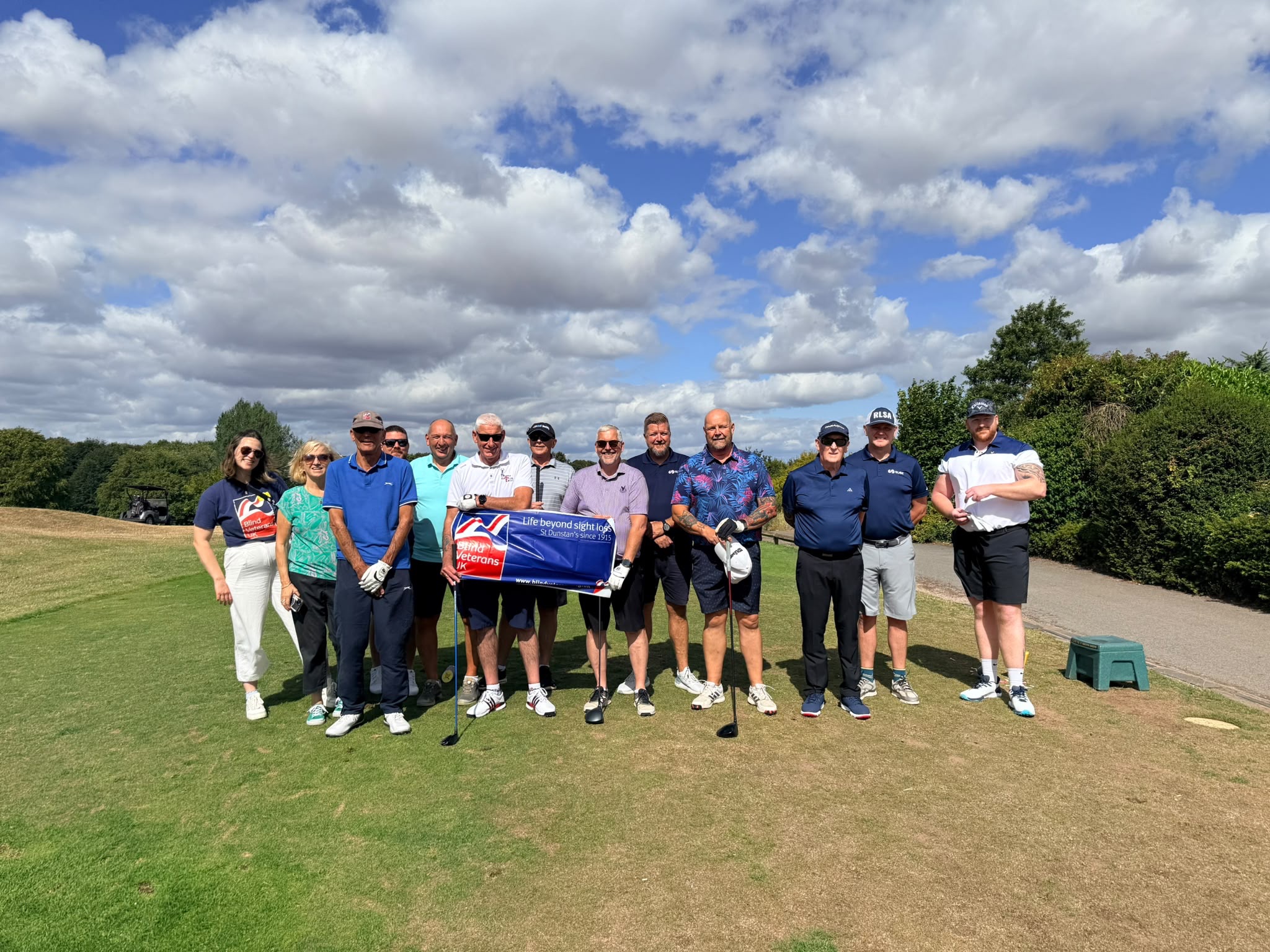 Blind veterans, SUEZ employees and support staff pose for a group photograph at Gaudet Luce Golf Club before play begins.