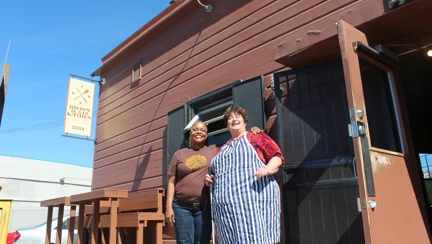 Photo of Tanya, left, showing blind Brit cook, Penny, right, the basics of her famous Creole cuisine in California