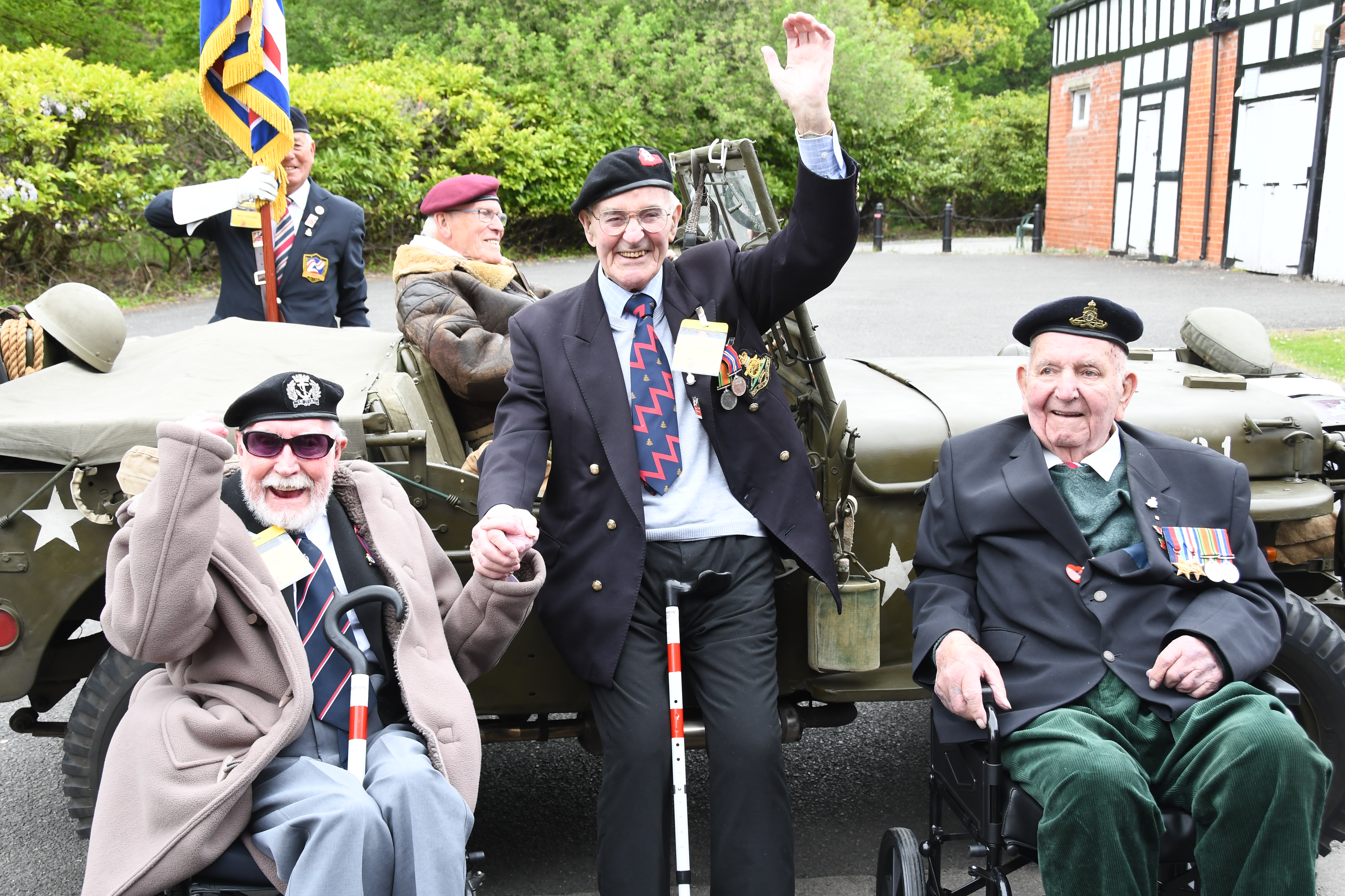 Two Second World War veterans and one younger veteran in a miliary vehicle celebrating VE Day 80 2025