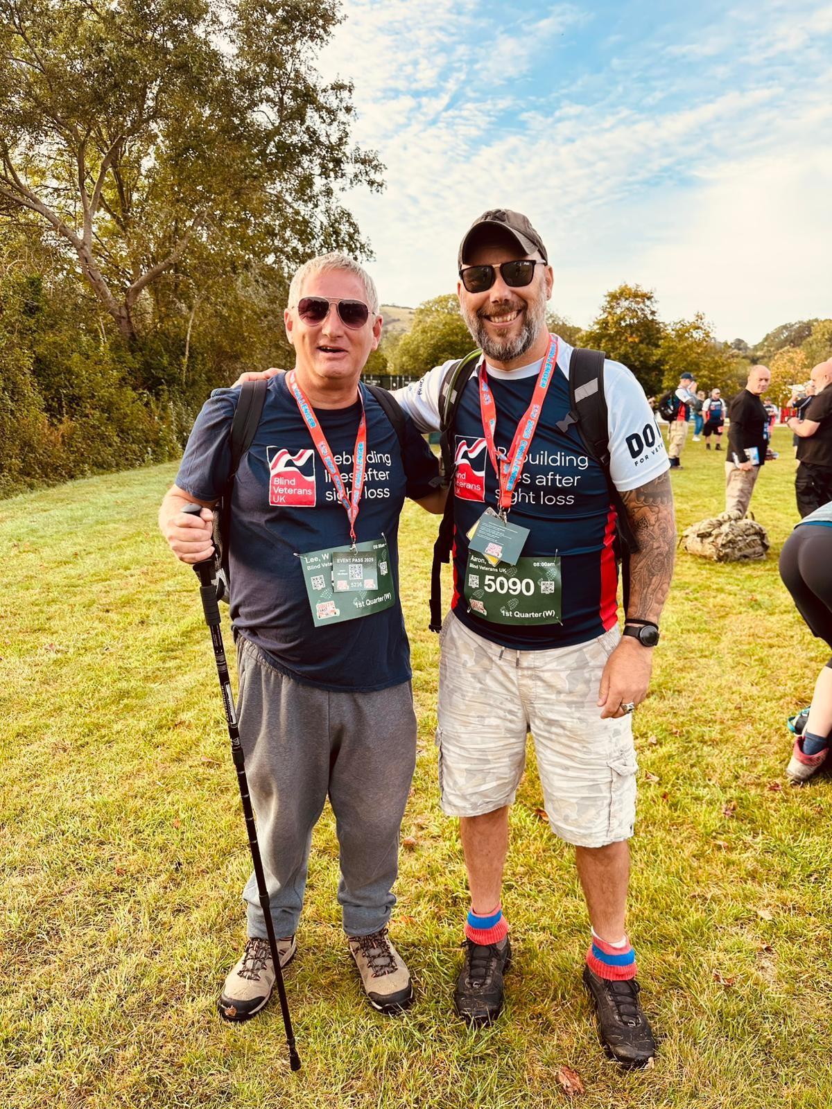 Lee and Aaron standing side by side smiling