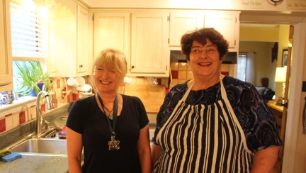 Photo of Kate, left, teaching Penny, right, her fish pie in Virginia Beach