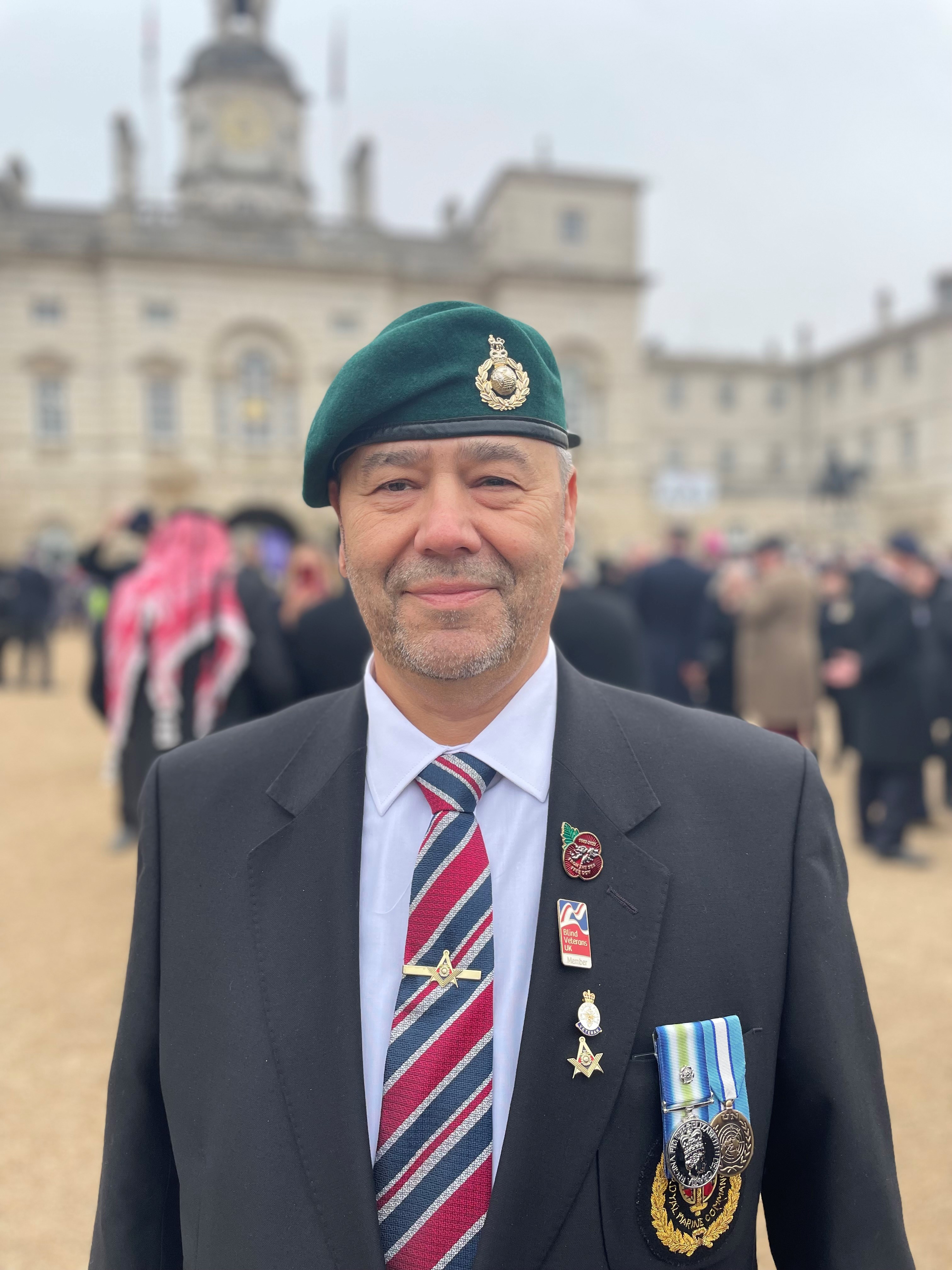 Alan wearing his Royal Marines beret, medals and Blind Veterans UK badge
