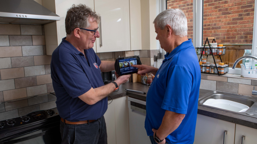 Blind veteran Steve with his community support worker, in his kitchen