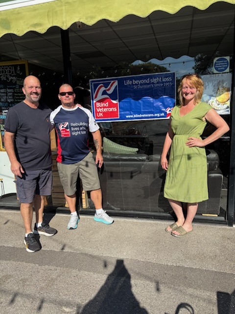 Mike and Anya with Stu outside their cafe