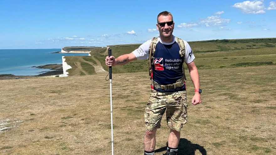 Charlie stood on the cliffs of the South Downs Way with his white cane