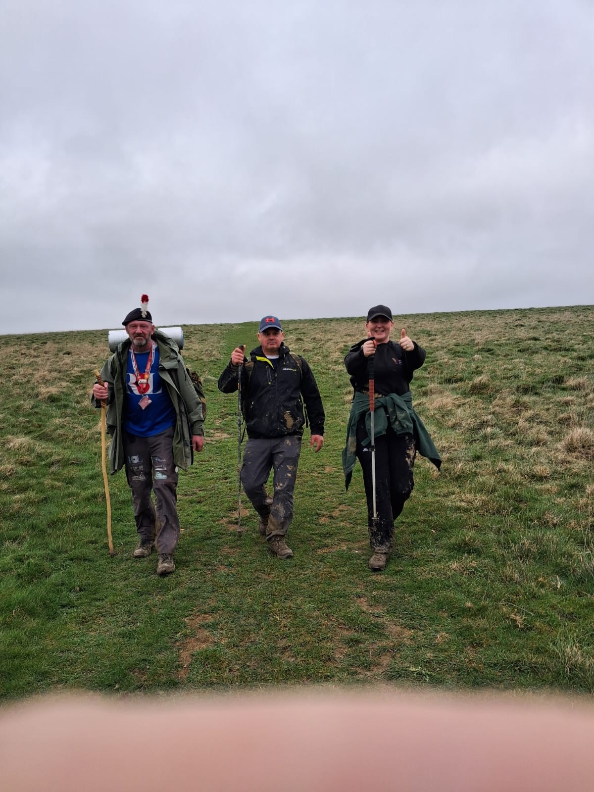 Stu, Jason and Poppy walking across a field