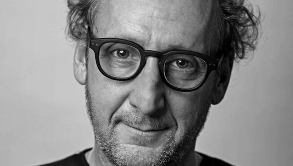 A black and white portrait of photographer Richard Cannon, wearing glasses