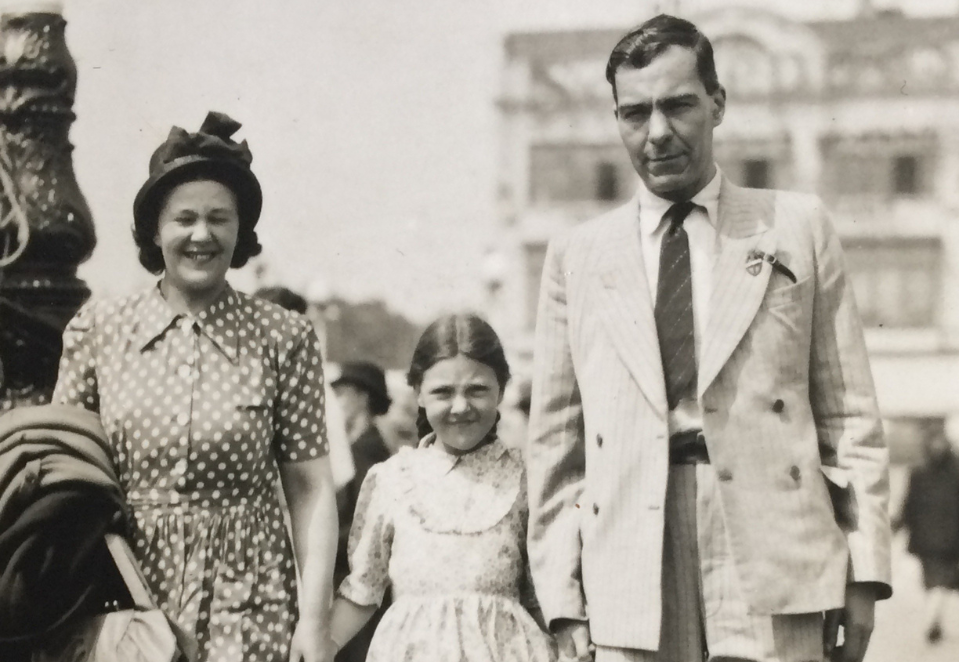 A black and white photo of blind veteran Claude with his wife and daughter in the 1940s