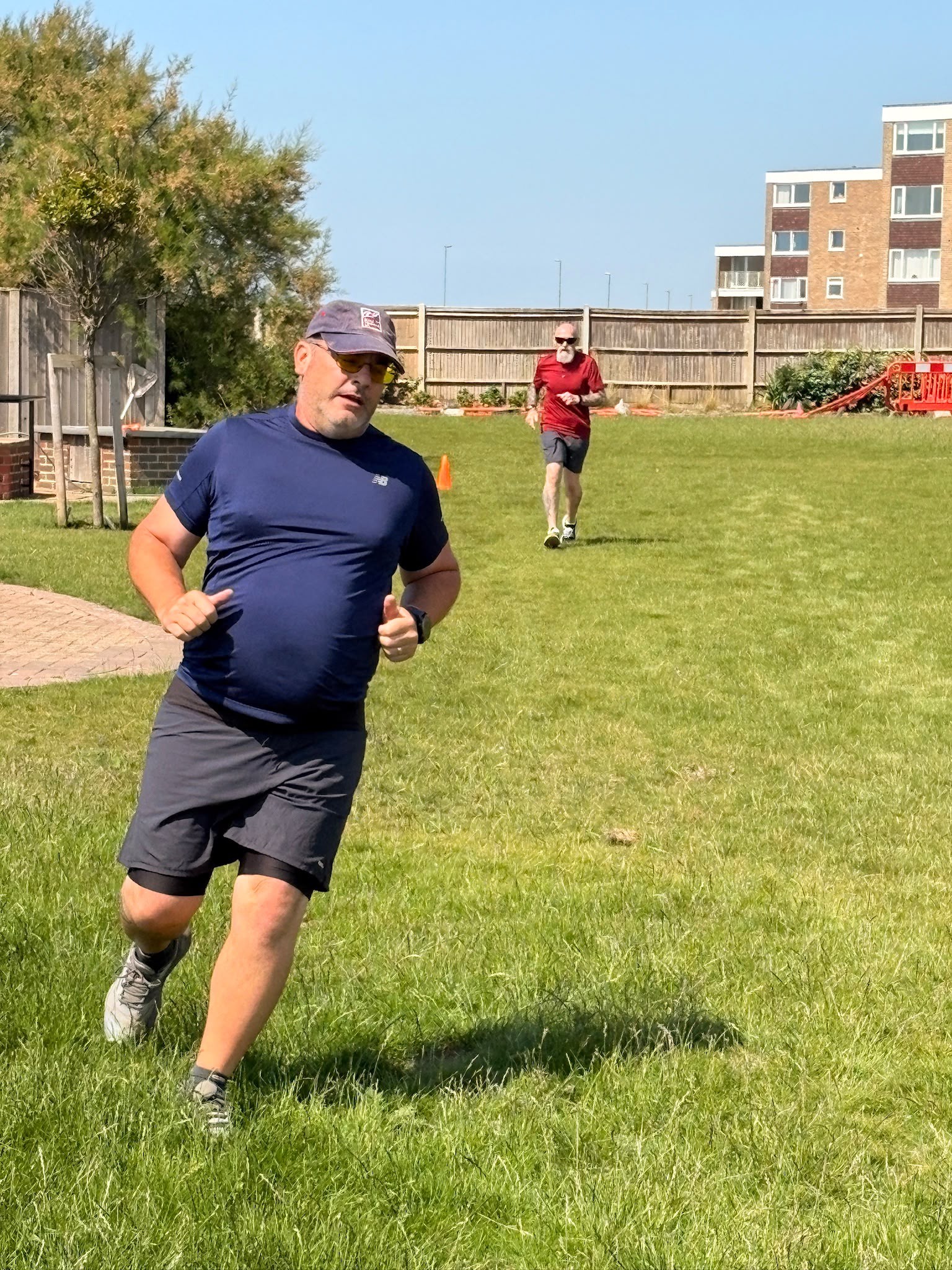 Andy and Jeff on the lawn at Rustington running between two cones spaced about 100 metres apart