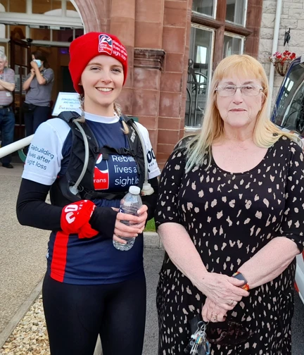 A photo of Star smiling, standing next to her mum at the Llandudno centre of Wellbeing at the end of her run