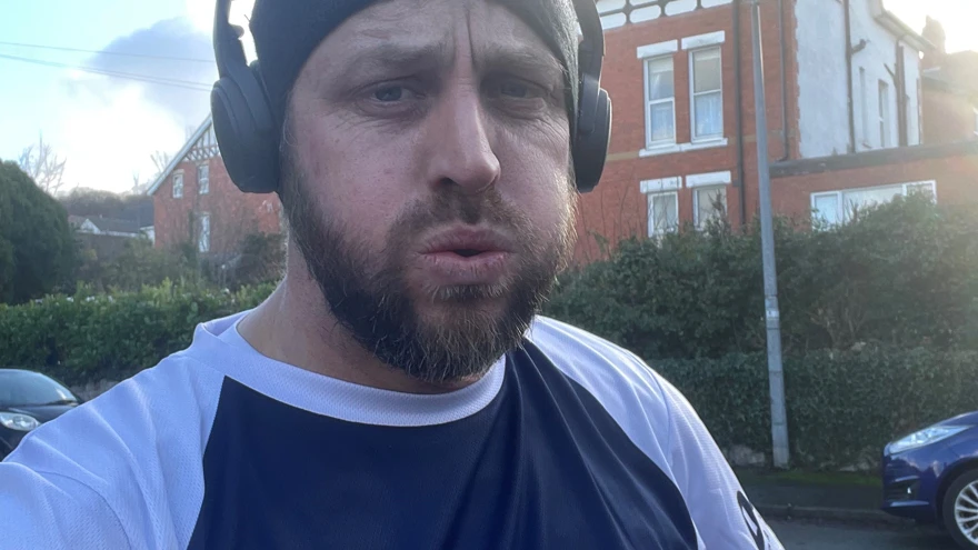 Matt at the end of a training run wearing a Blind Veterans UK t shirt
