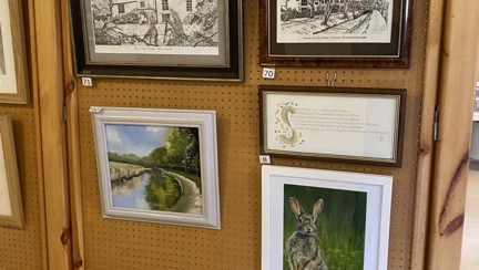 A close up of a display board with five framed pictures
