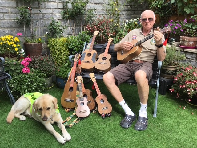 Hayden with his guide dog and ukulele