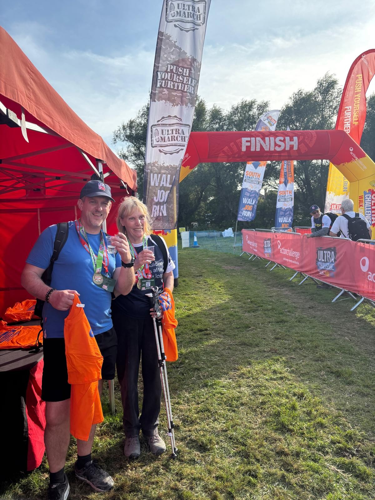 Jill and her guide Phil at the finish with a glass of prosecco 