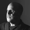 A black and white portrait of illustrator Martin Impey