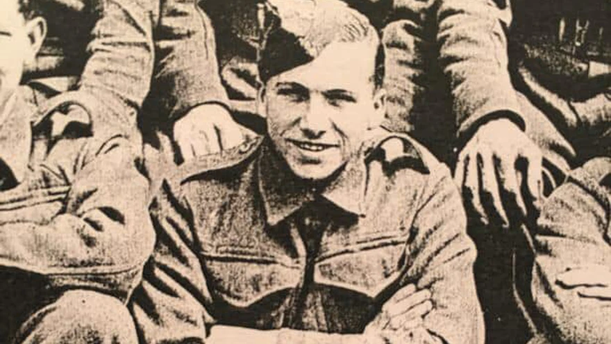 A black and white photo of blind veteran George in his military uniform