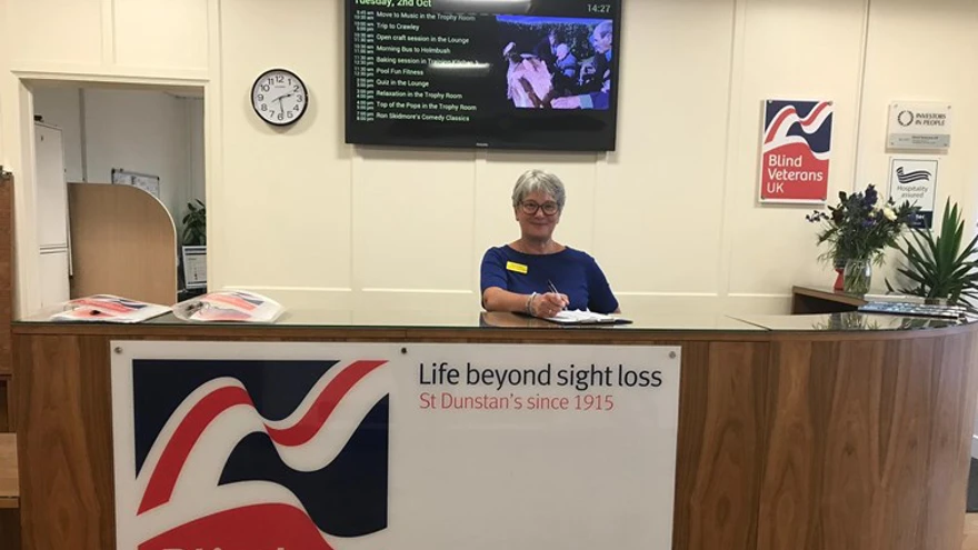 A receptionist smiling at Brighton centre reception