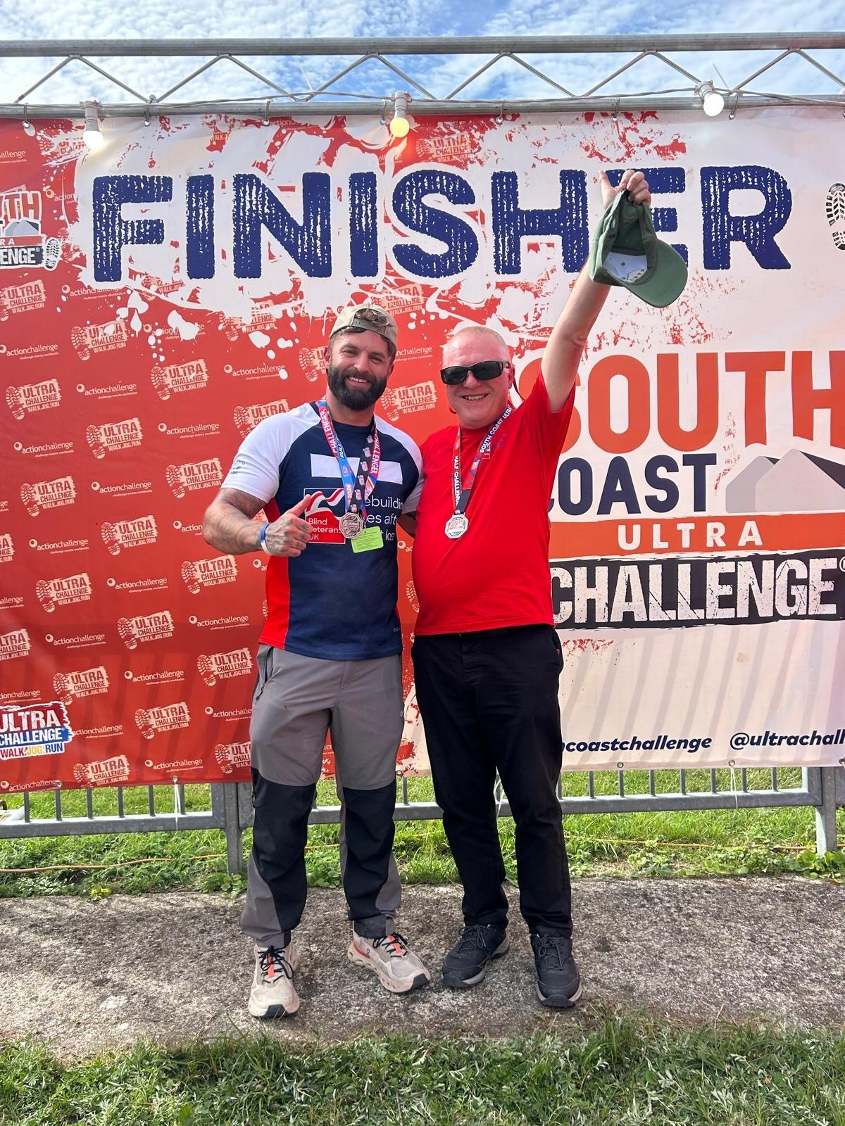 Rob and Jack stand at the finish banner