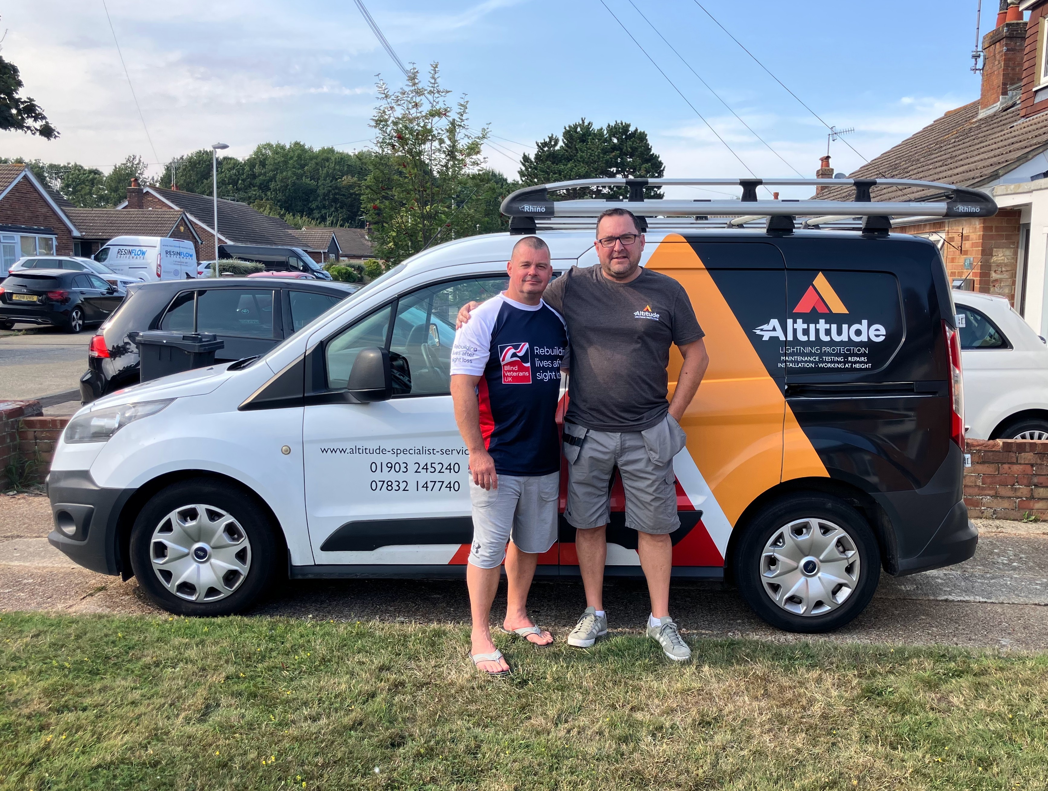 Stu and Sean are stood together in front of Sean's work van