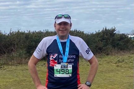 Picture of Andrew wearing his Blind Veterans UK running top