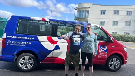 Wayne and Theresa are stood outside the Rustington Centre and stood in front of a Blind Veterans UK minibus