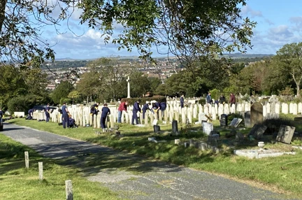 Several volunteers pictured cleaning and restoring graves at Brighton Cemetery