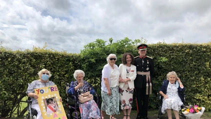Photo of Blanche, Residential Care Manager with some of our veterans
