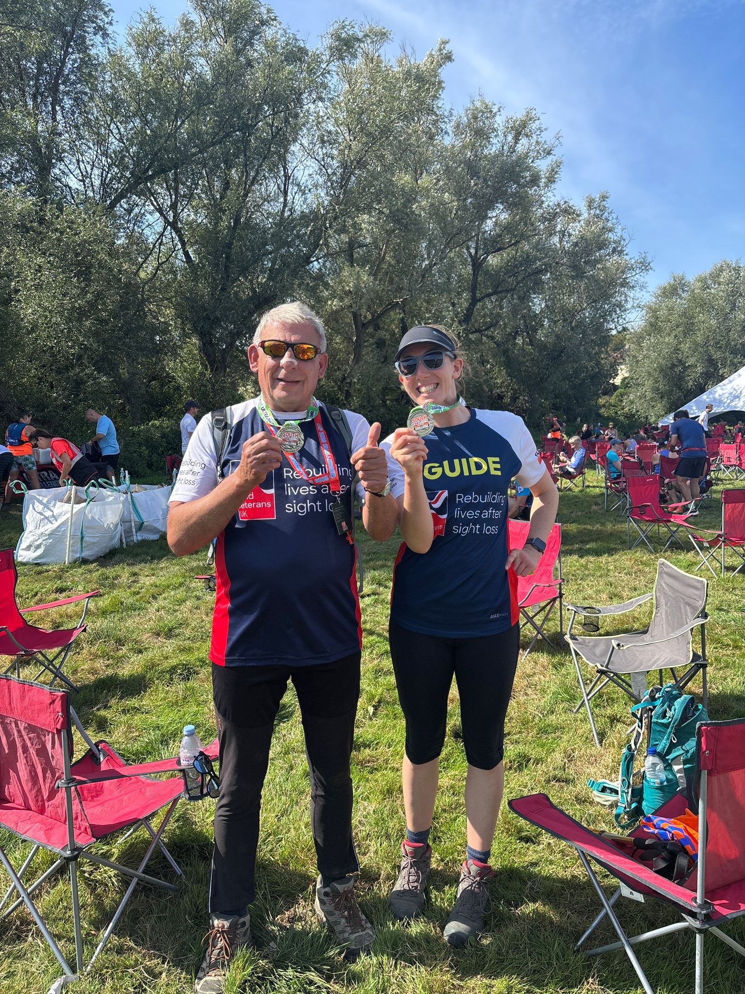 Richard and Theresa in their Blind Veterans UK T-shirts proudly hold up their medals