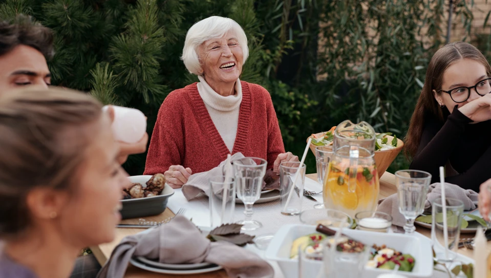 A photo of a happy family enjoying dinner in garden