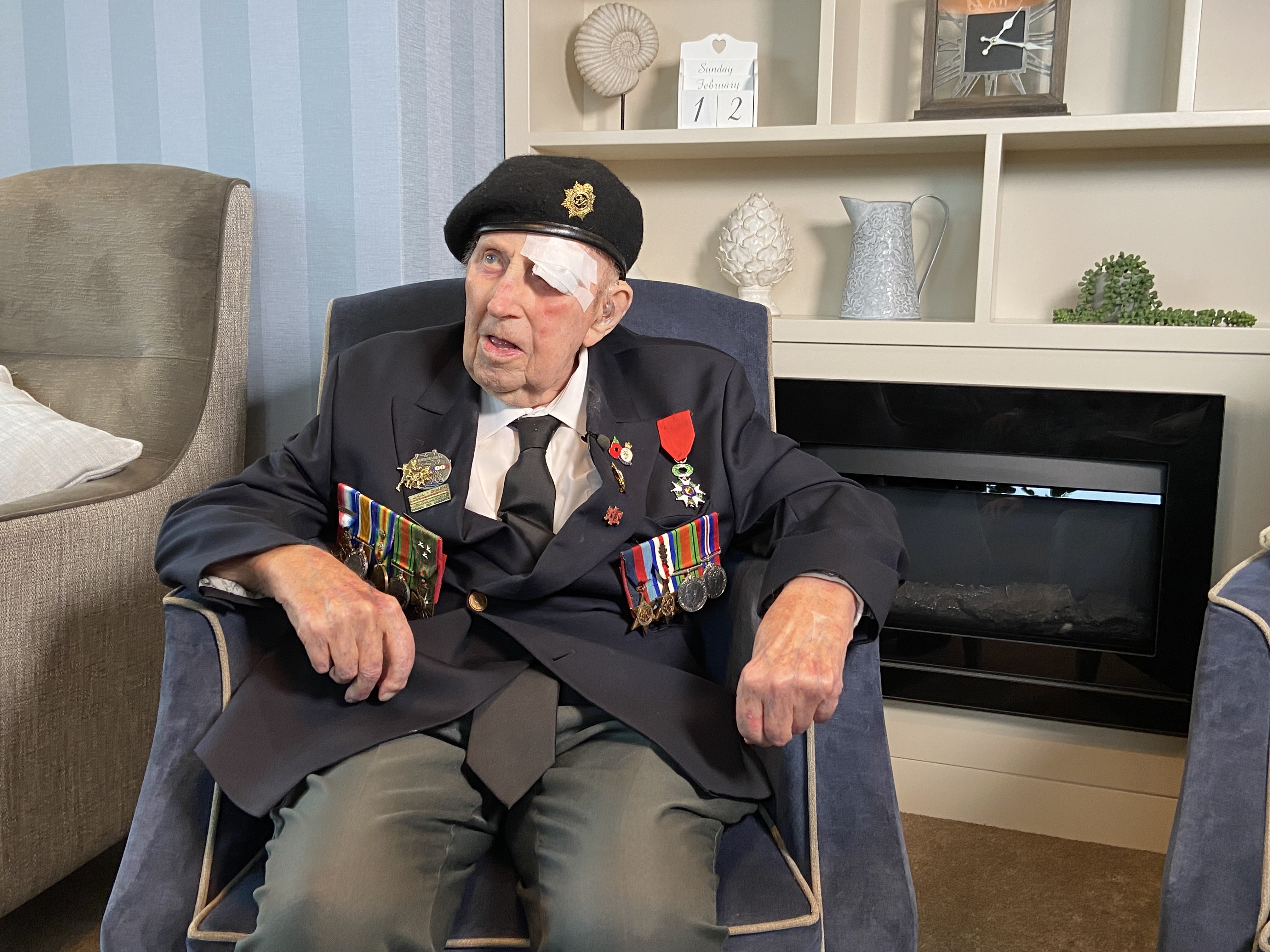 Blind veteran Ken wearing a blazer, beret and medals