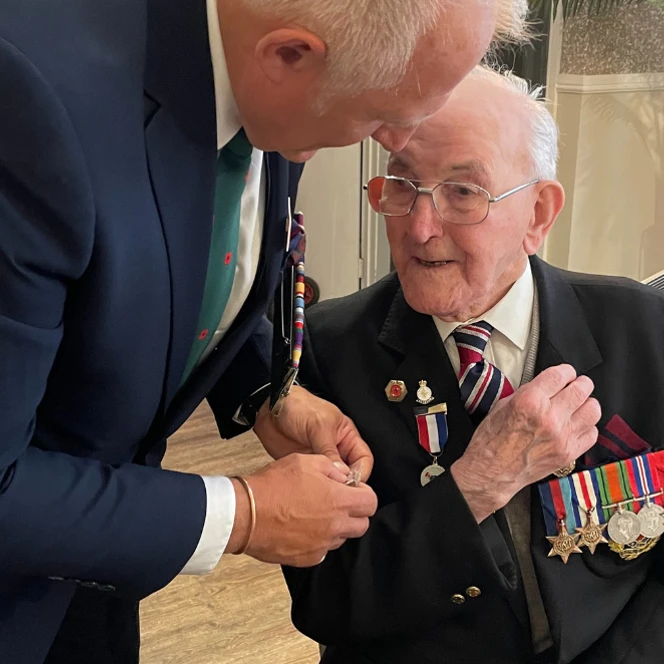 Blind veteran Richard wearing his medals at a D-Day 80 event.