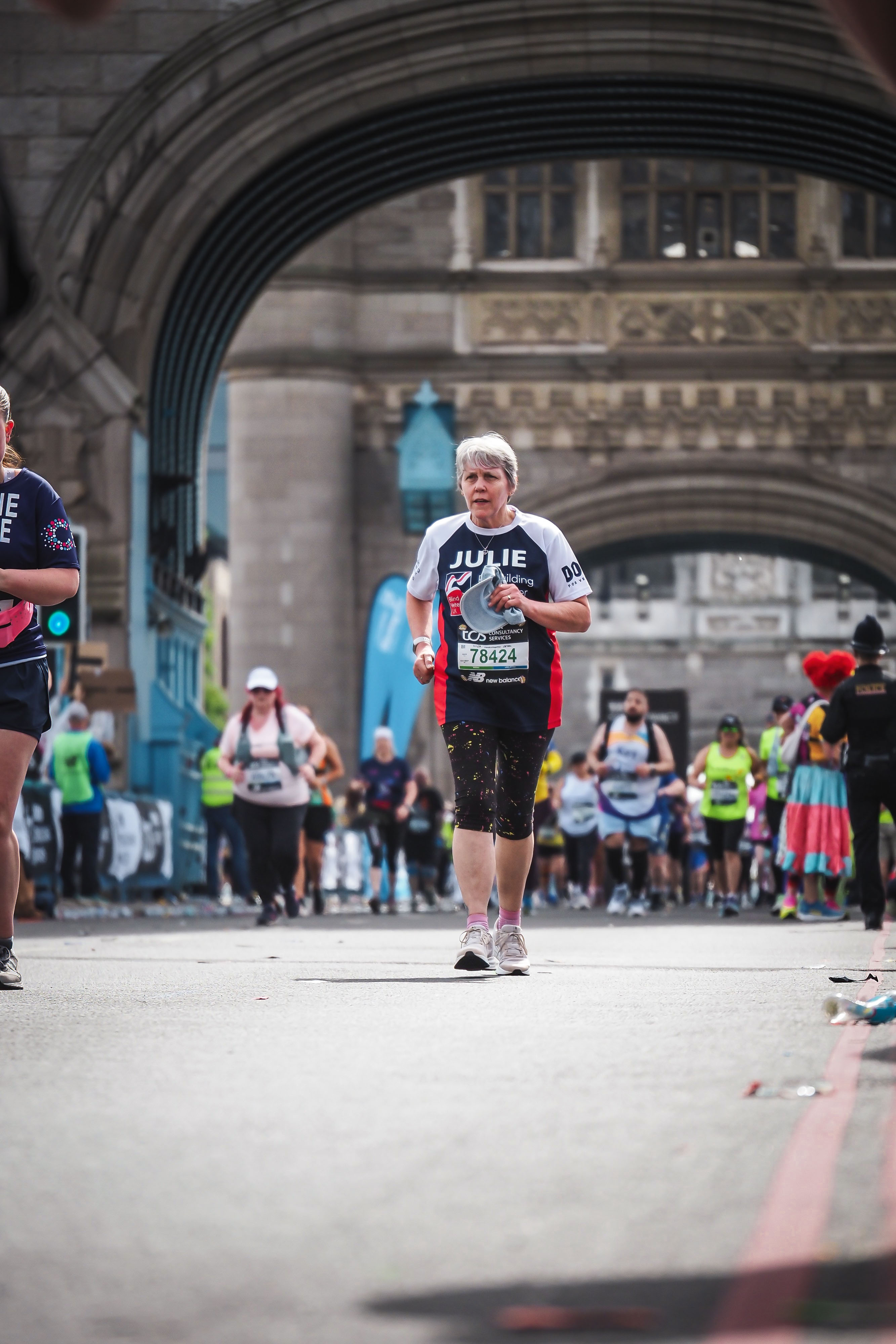 Julie mid-run with other runners around her as they make their way across Tower Bridge