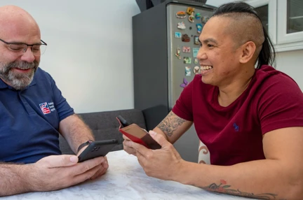 Blind veteran Ken being taught to use a smart phone