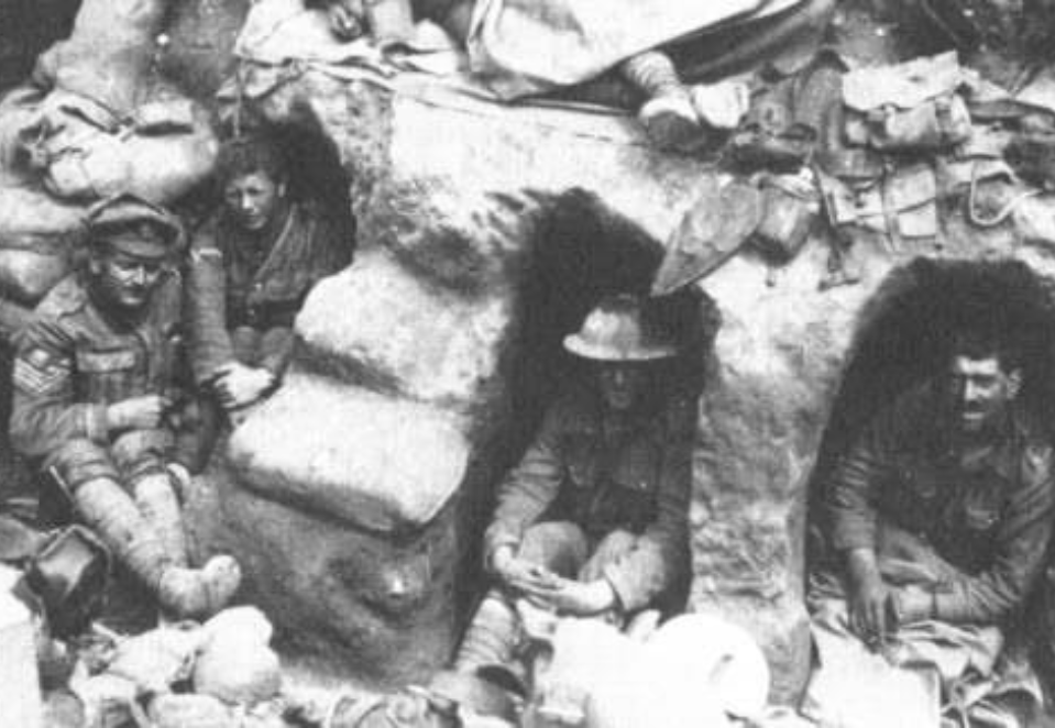 Black and white photo of a group of soldiers in down time in the trenches at Thiepval, Somme.