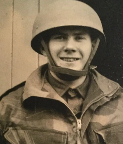 A sepia photograph of Danny in his Army uniform and tin hat