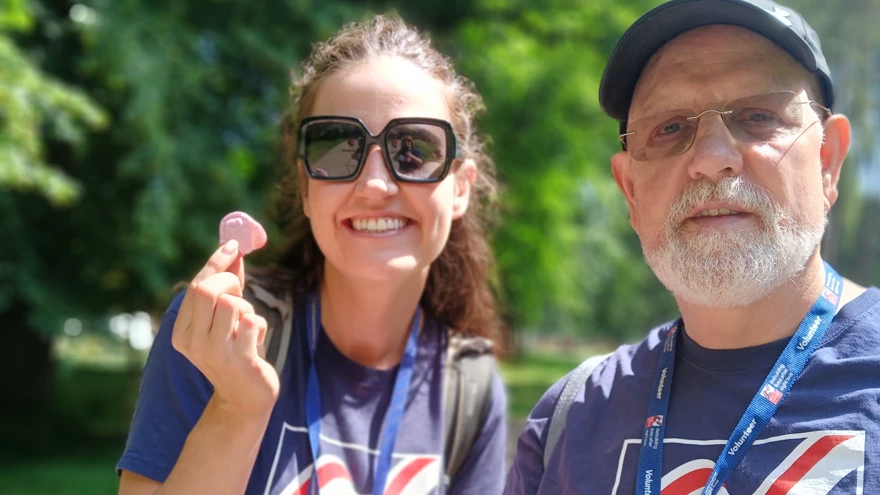 Olga and Phil both in Blind Veterans UK T-shirts stop along the way to eat a bag of sweets
