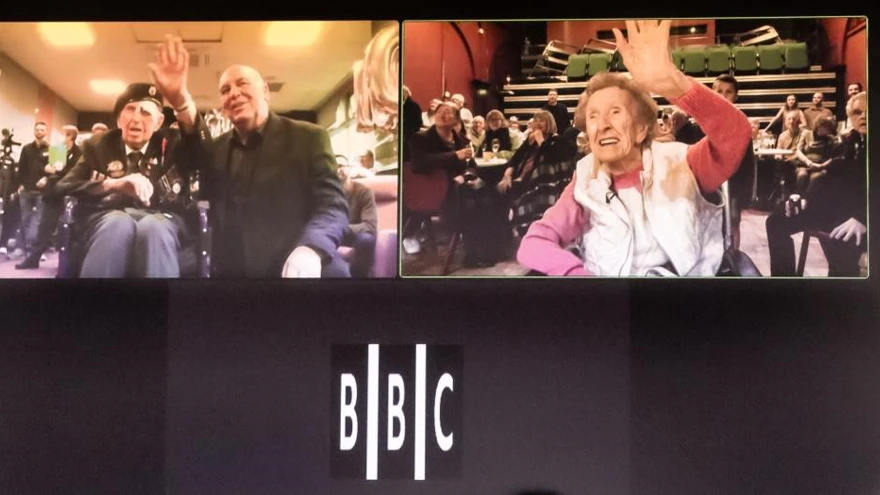 A screen showing blind veterans Ken and Margaret on their 100th birthdays