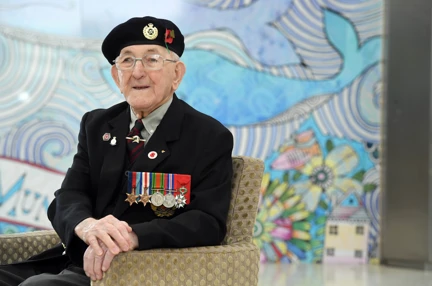 Blind veteran Richard wearing a beret and his medals