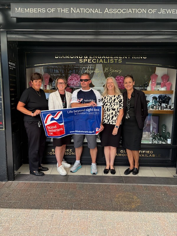 Stu stood outside L Guess Jewellers with their team