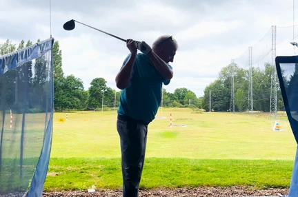 Blind veteran Kev swinging a golf club