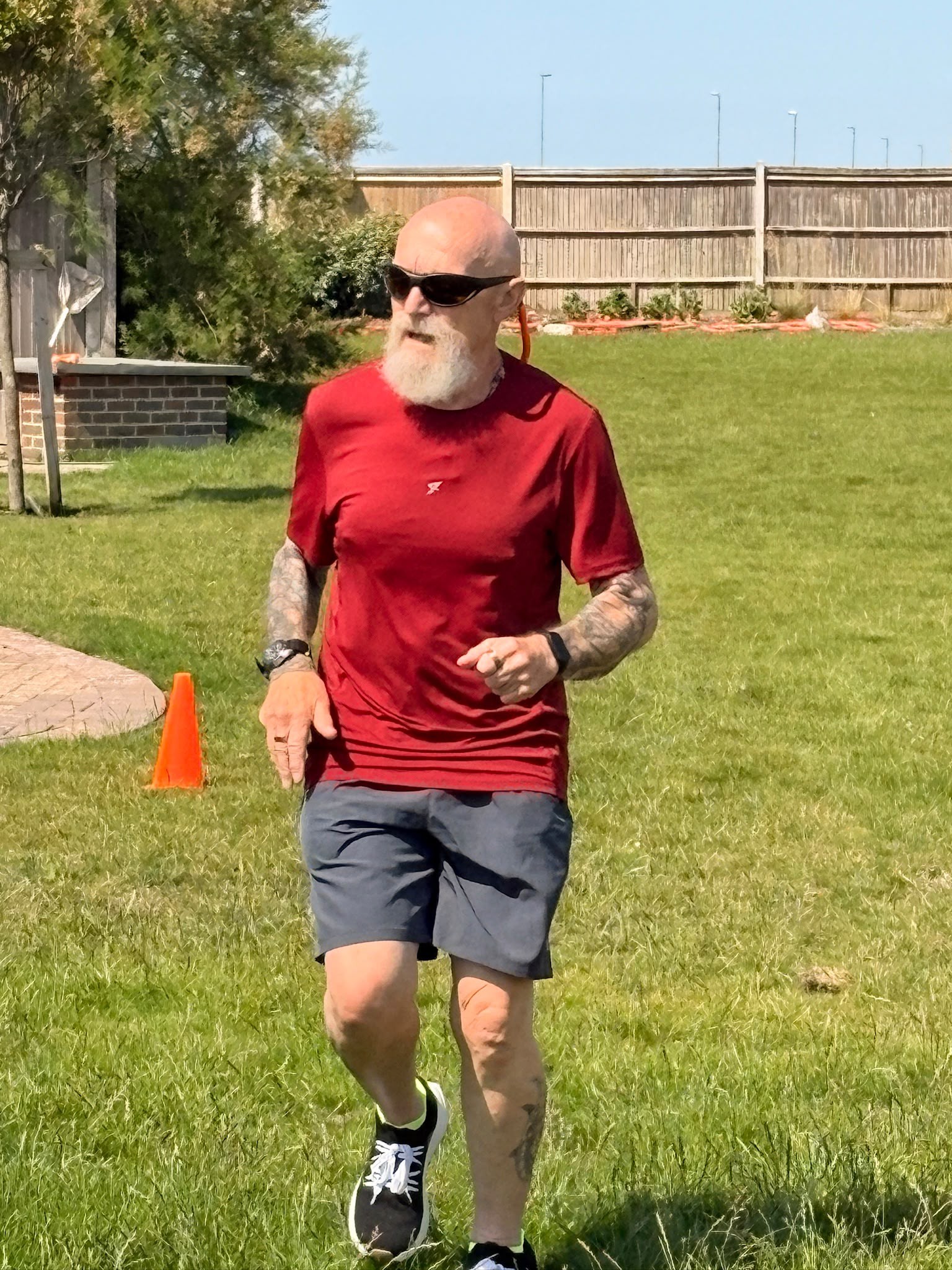 Jeff running between two cones spaced 100 metres apart on the lawn at Rustington