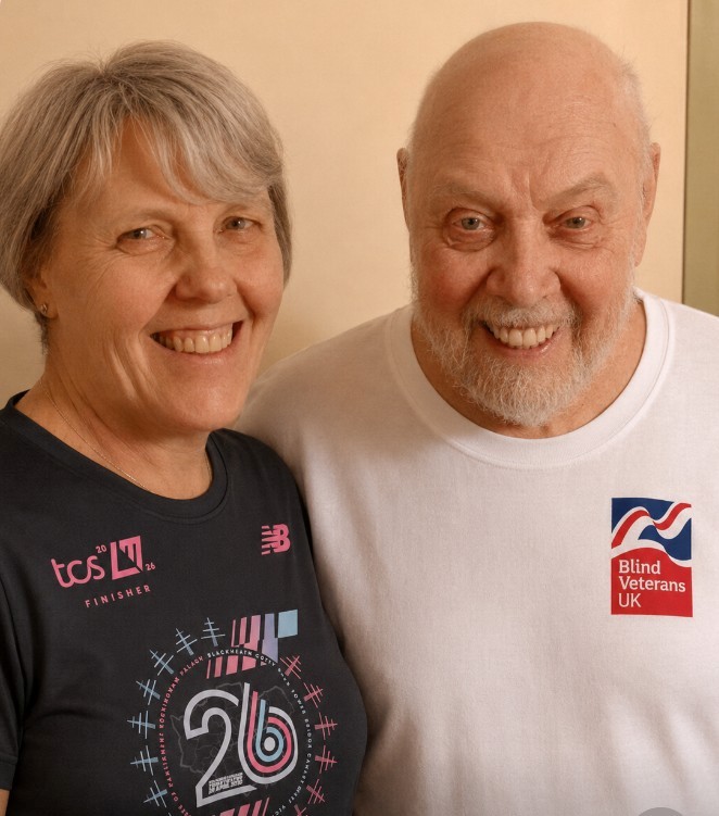 Julie and her dad smiling. Julie is in a London Marathon t-shirt and her dad is wearing a Blind Veterans UK T Shirt
