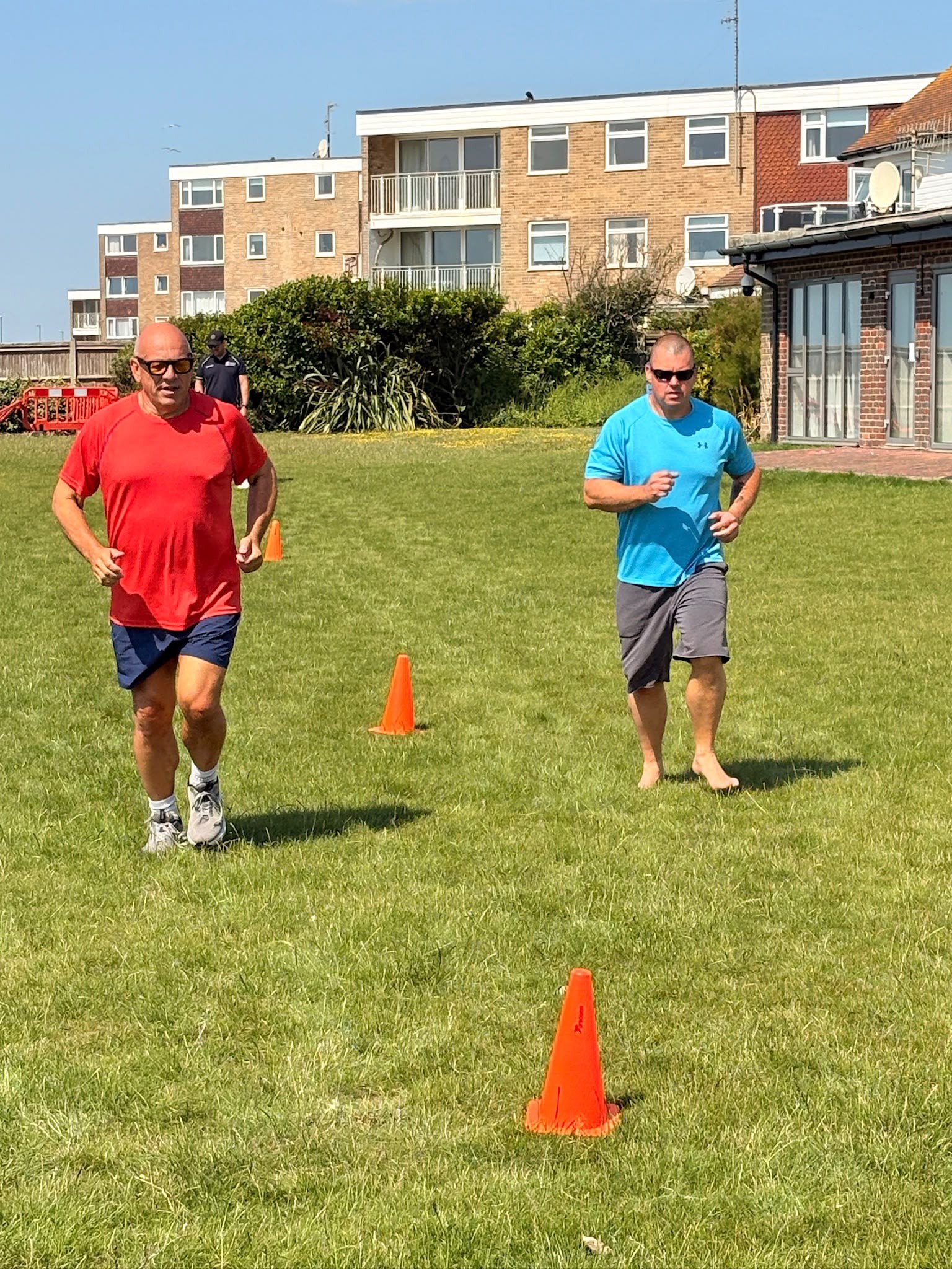 Stu and Jerry are running between cones spaced 100m apart on the Rustington Centre lawn. Stu is running bare foot.