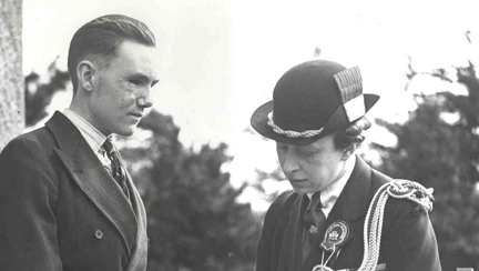 A photo of blind veteran Bill Cowing in 1941, talking to a visiting Princess Mary