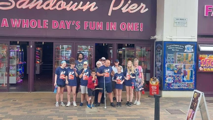 The group of walkers pose for a picture at Sandown Pier