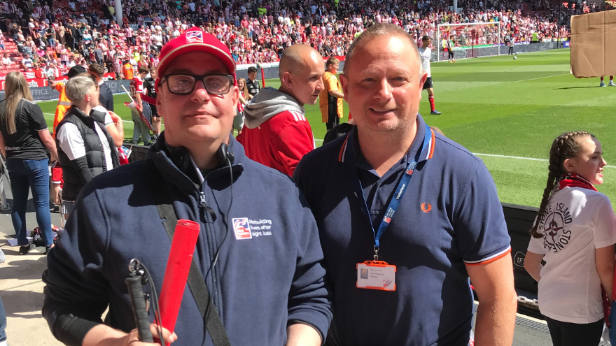 David at a football match with blind veteran Carl